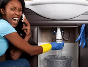 Emergency plumbing repair for a leaking sink drain under a bathroom vanity in Orlando, FL