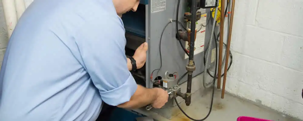 Furnace repair technician inspecting and servicing a home heating system in Orlando, FL