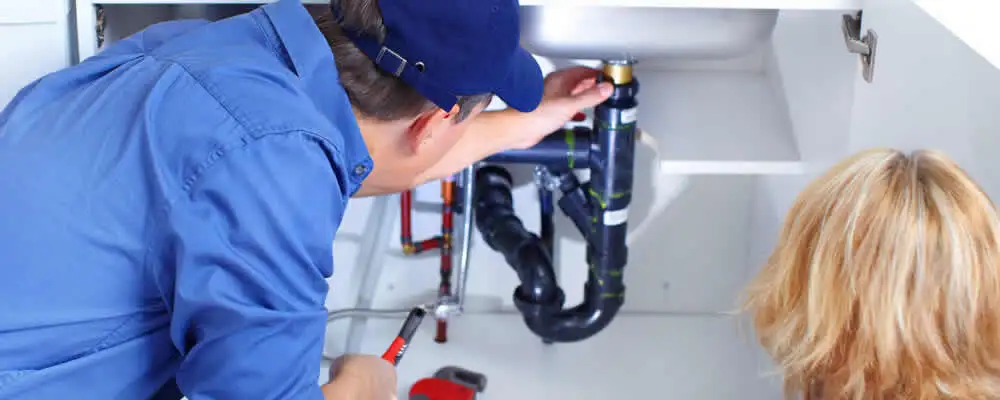 Plumber repairing under-sink drain pipes and fittings in Orlando, FL